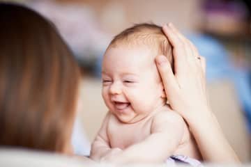 When does a baby hold its head up?