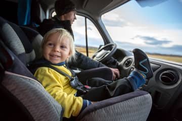 When can a child sit in the front of the car?