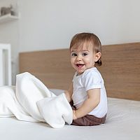 12-month-old baby ina a bed