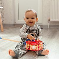 12-month-old baby with a toy